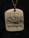 Mayokok ivory scrimshaw necklace featuring seals on an ice floe